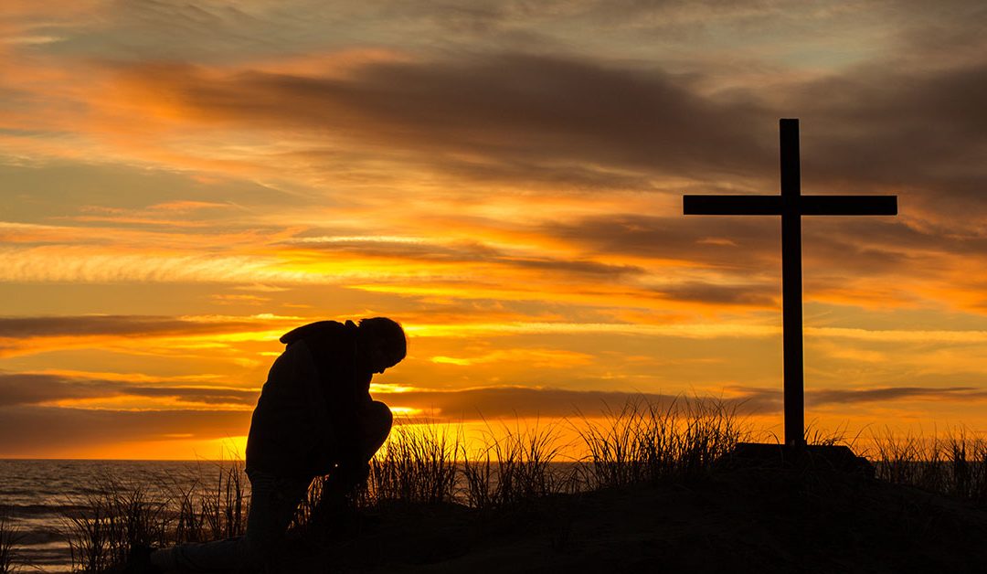 Man bowing down at the cross